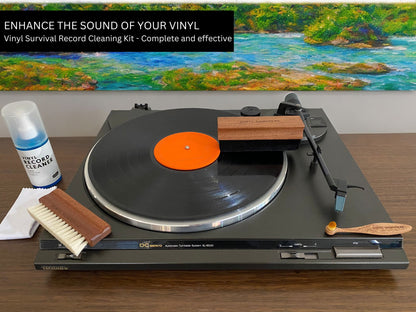 The items of the vinyl survival record cleaning kit laid out on and next to a record player