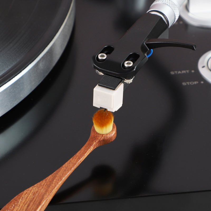 Stylus brush cleaning a record player needle